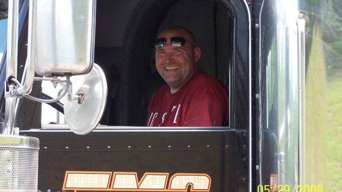 Driver smiling from window of his truck