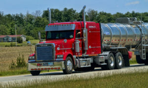 Red truck hauling a tanker 